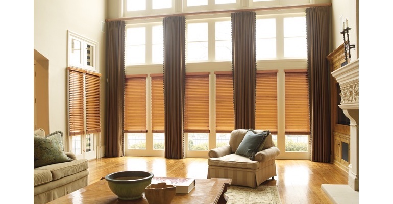 Boston great room with wooden blinds and floor to ceiling draperies.